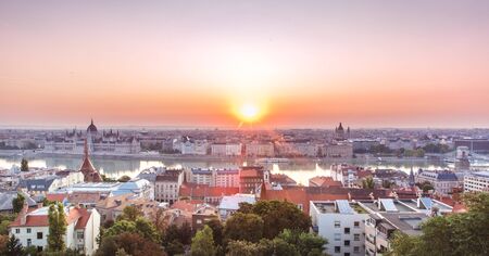 Panoramic cityscape of Hungarian parliament building and Saint Stephen basilica on the Danube river. Colorful sunrise in Budapest, Hungaryの写真素材