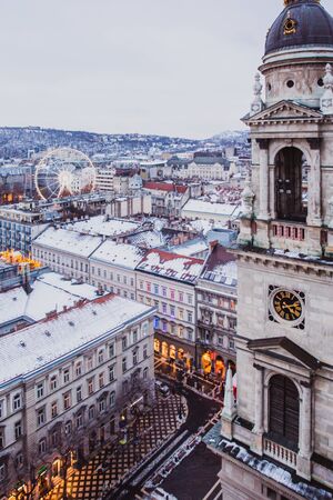 View of Budapest from St. Stephens Basilica, Budapest, Hungary on a snowy foggy day. Snow lies on...