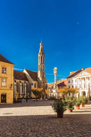 Sopron, Hungary - October 2018: Trinity statue and Goat Church in old center in Sopron, Hungaryのeditorial素材
