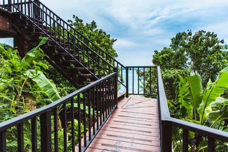 Staircase upstairs with sea view with leaf framesの写真素材