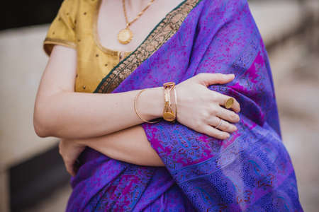 Young european woman with short hair in purple traditional saree. Outdoor portrait. India, Bangalore