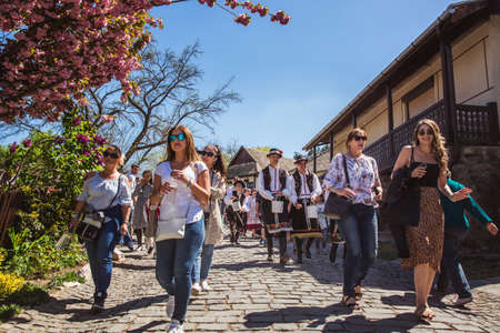 HOLLOKO, HUNGARY - April 12, 2019 Easter festival in the folklore village of Holloko in Hungary. Guys sprinkle water on girlsのeditorial素材