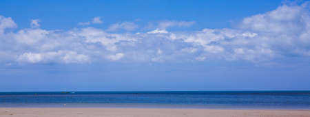 Tropical sandy beach and clear blue sea with beautiful sky with clouds.の写真素材