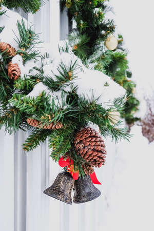 Christmas wreath on gate outside covered with snow