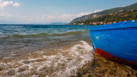 Waves hit the boat on the lake shore, underwater