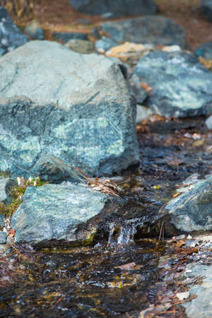 Cropped image of natural waterfall, water falling over the stoneの写真素材