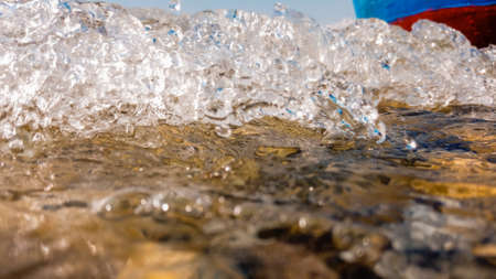 Waves hit the boat on the lake shore, underwaterの写真素材