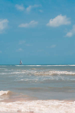 Small white sail yacht sailing in blue sea