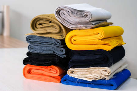 Stack of colorful natural fabrics on the table.の写真素材