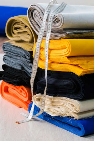 Stack of colorful natural fabrics on the table.の写真素材