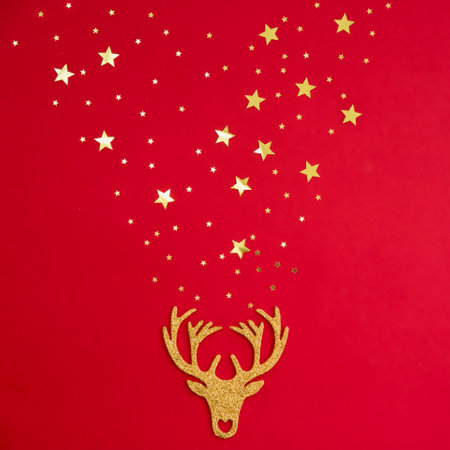 Decorative Christmas decorations deer on a red background with gold stars sparklesの写真素材