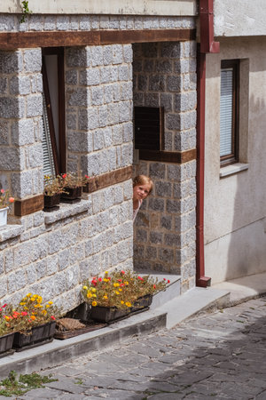 Little girl walks along a cobbled street in the old town of Ohrid, Republic of North Macedoniaの写真素材