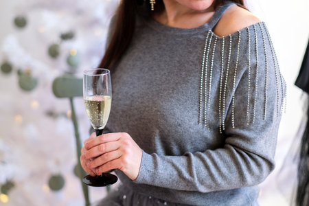 Woman celebrating New Year with glass of champagne in her hand.の写真素材