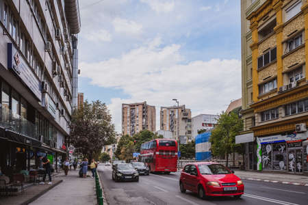 Skopje, Republic of North Macedonia - August 2021: Central street and double decker red bus designed for Skopje city public transportation, Republic of North Macedoniaのeditorial素材