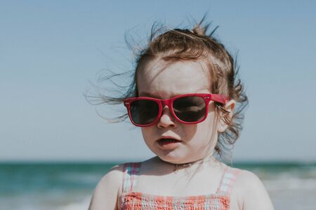 Girl on the sea in pink glassesの写真素材