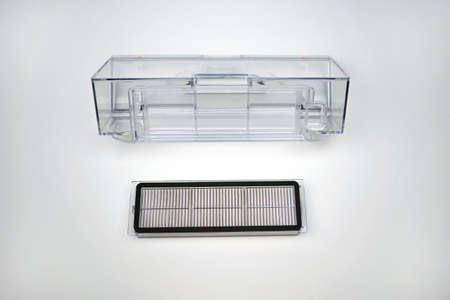 Filter and container for the robot vacuum cleaner on a white background. New spare parts for the...