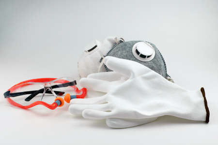 Safety glasses, earplugs, dust mask, gloves and earplugs. Personal protective equipment for workers,...