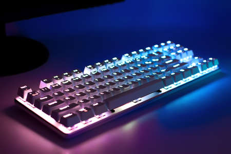 Gaming keyboard with RGB light. White mechanical keyboard with backlight, soft focus. The concept of...