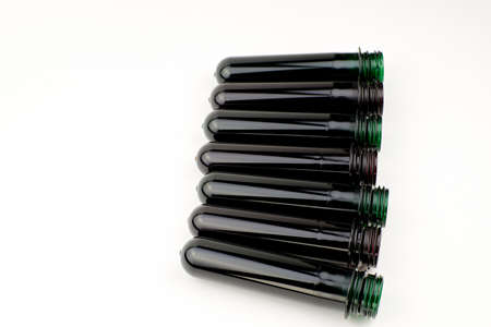 PET preforms on a white background, copy space. Blanks for creating plastic bottles
