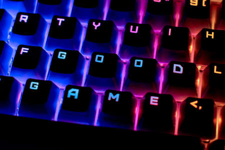 Word is a Good Game on the keyboard. The concept of gaming or esports. Keyboard with RGB light, blurred background.の写真素材