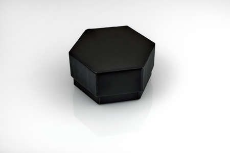 Black hexagonal box. Cardboard hexagonal box on a white background with reflectionの写真素材
