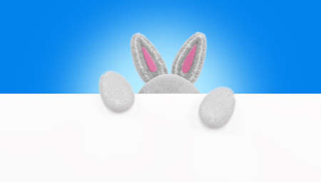 Cartoon rabbit holds space for text. Furry rabbit ears, 3d render. Happy Easter banner, poster, greeting card, copy space.の写真素材