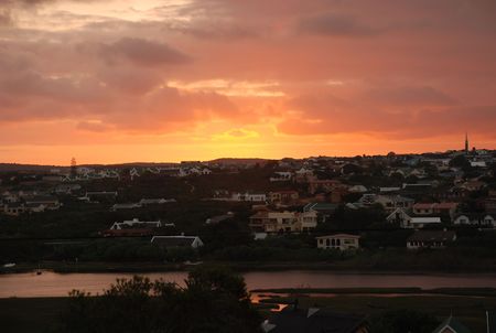 Golden sunset over river townの写真素材