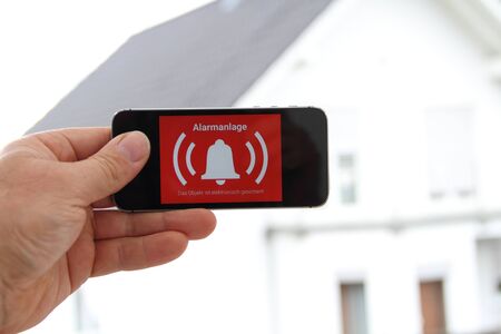 Mobile phone with a picture alarm system and the text "Alarm"の写真素材