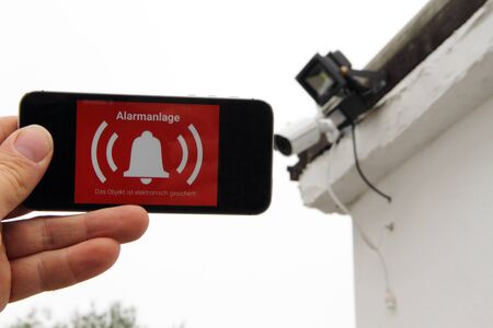 Mobile phone with a picture alarm system and the text "Alarm"の写真素材