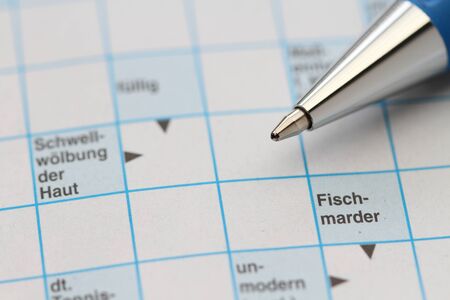 A crossword puzzle with a penの写真素材