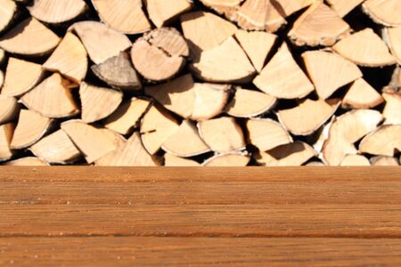 Table with firewood as a backgroundの写真素材
