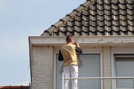 A painter at work on the scaffoldの写真素材