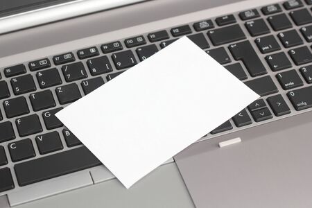 An empty piece of paper on a keyboardの写真素材