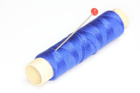 A spool of thread with a needle