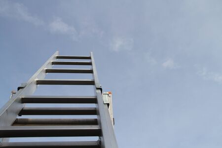 A man is trying to get up the ladder