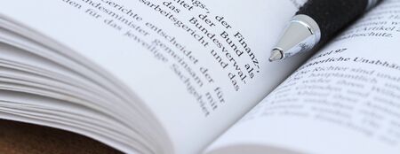 An open book with pen and the text article