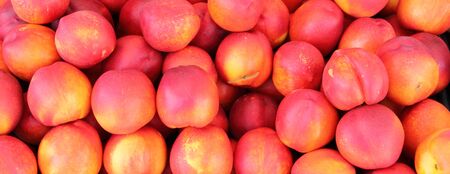 Many peaches in a market