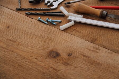 Drill and screw on a wooden board
