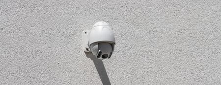 Security camera on a house wallの写真素材