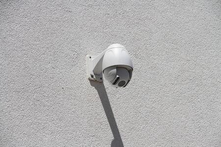 Security camera on a house wallの写真素材