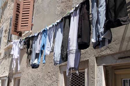 Laundry is hung to dry out the windowの写真素材