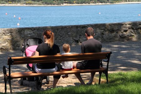 A family is sitting by the waterの写真素材