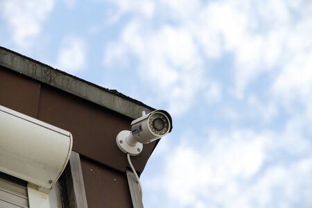 Security camera on a house wallの写真素材