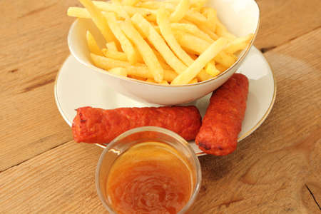 delicious french fries with cevapcici rolls and dipの写真素材