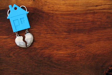 a house with a broken heart on a wooden plank symbolizing divorceの写真素材