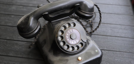 an old, dusty black rotary phone