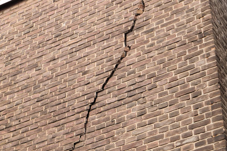 an old brick wall with a large crack