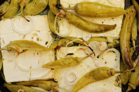 Baked feta cheese with pepperoni and onionsの写真素材