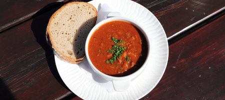 goulash soup with a slice of breadの写真素材
