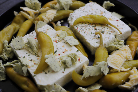 Baked feta cheese with pepperoni and onionsの写真素材